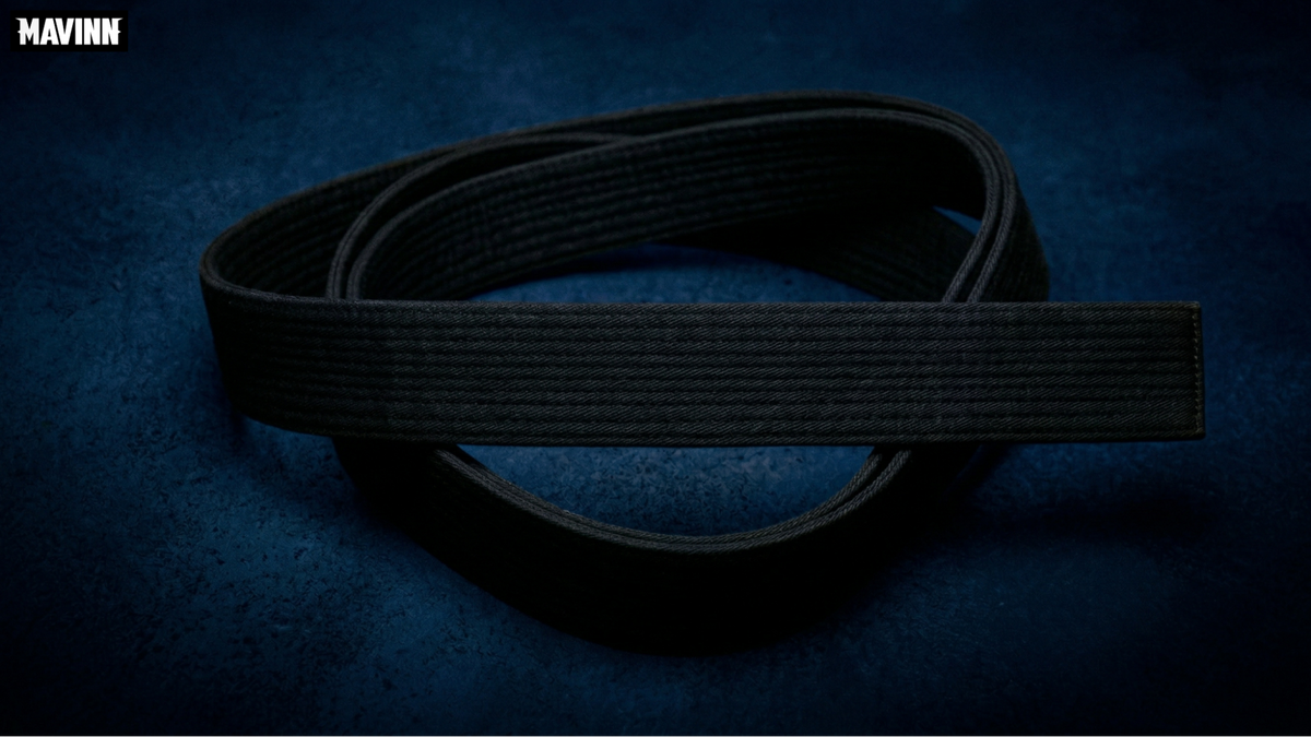 Coiled black belt Muay Thai martial arts equipment on dark background